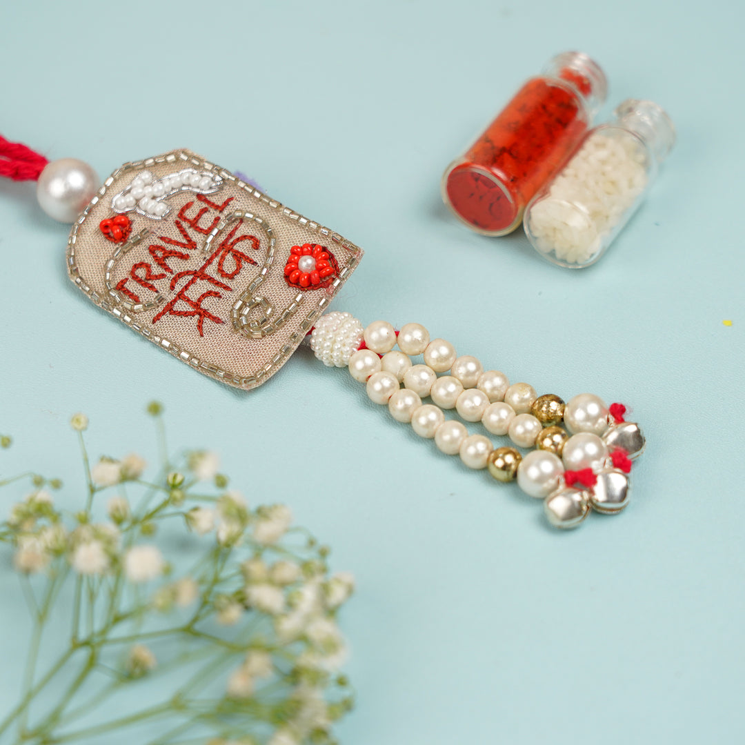 Handmade Beaded Travel Freak Lumba Rakhi For Bhabhi With Roli Chawal - Close-up View of Tassel
