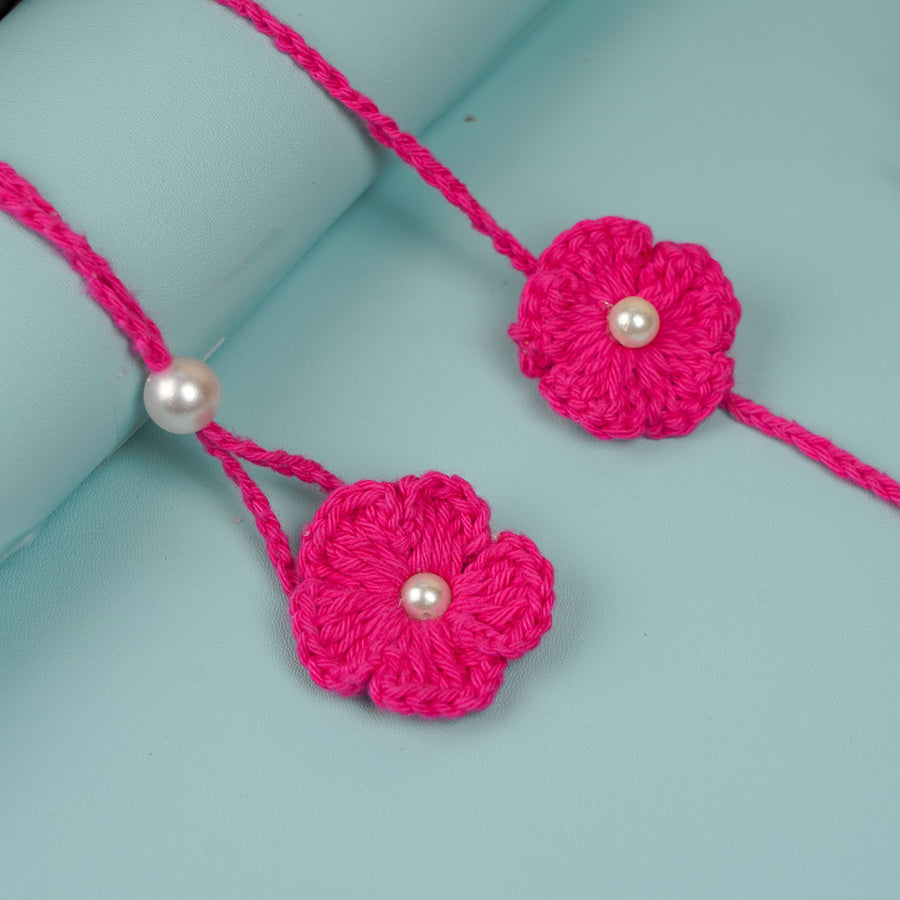 Handmade Crochet Scarlet Knot Bhaiya Bhabhi Rakhi With Roli Chawal - Close-up of flower and pearl