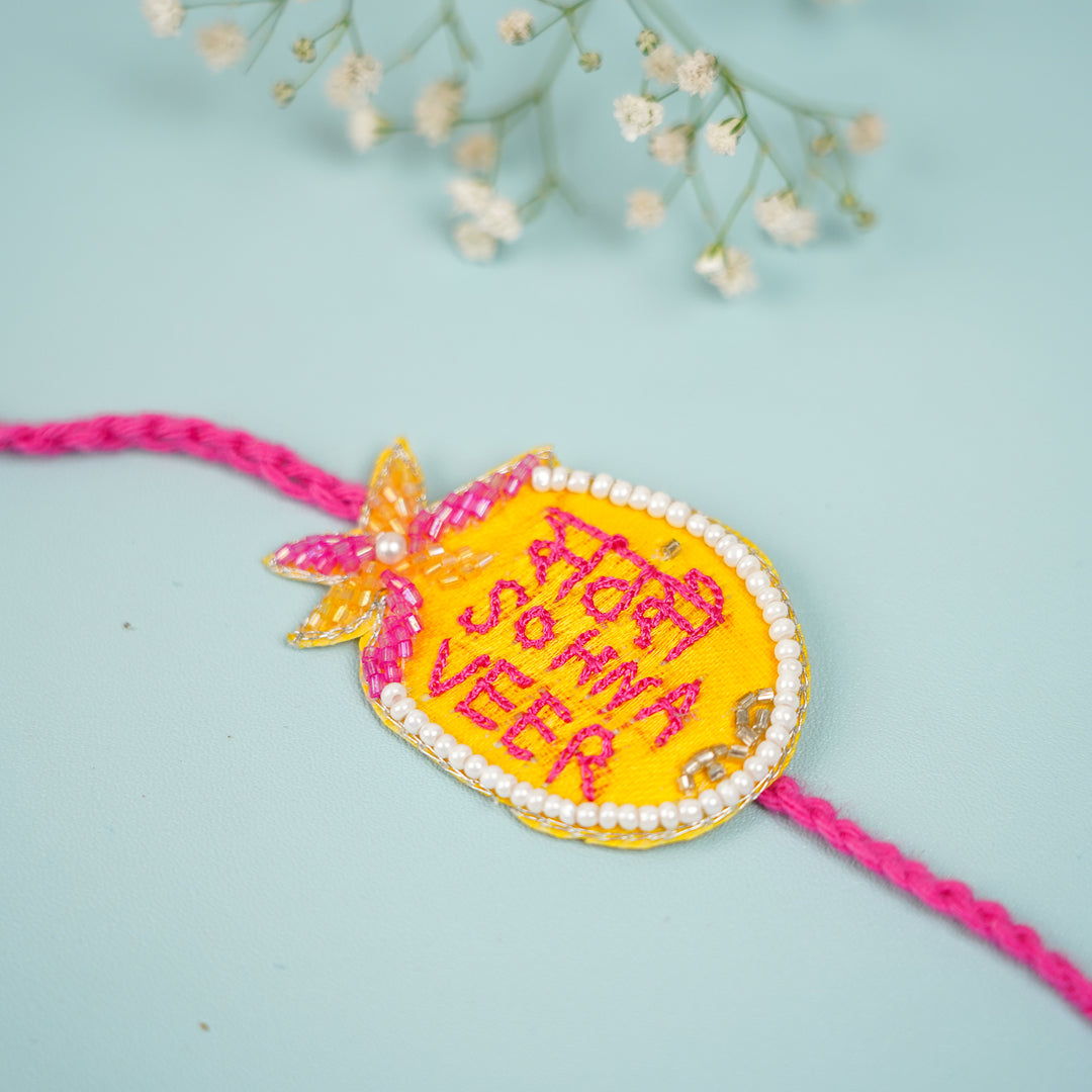 Handmade Beaded Sabse Sona Bhaiya Bhabhi Rakhi With Roli Chawal - Close-up of Embroidered Pendant