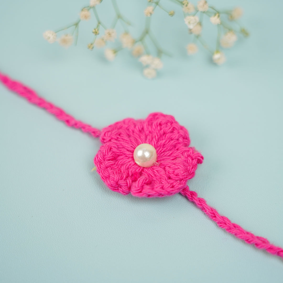 Handmade Crochet Scarlet Knot Bhaiya Bhabhi Rakhi With Roli Chawal - Macro close-up of flower detail