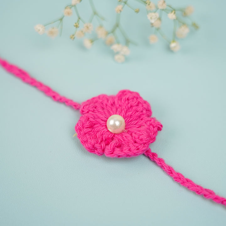 Handmade Crochet Scarlet Knot Bhaiya Bhabhi Rakhi With Roli Chawal - Macro close-up of flower detail