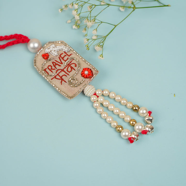 Handmade Beaded Travel Freak Bhaiya Bhabhi Rakhi With Roli Chawal - Side Angle Focus on Tassels