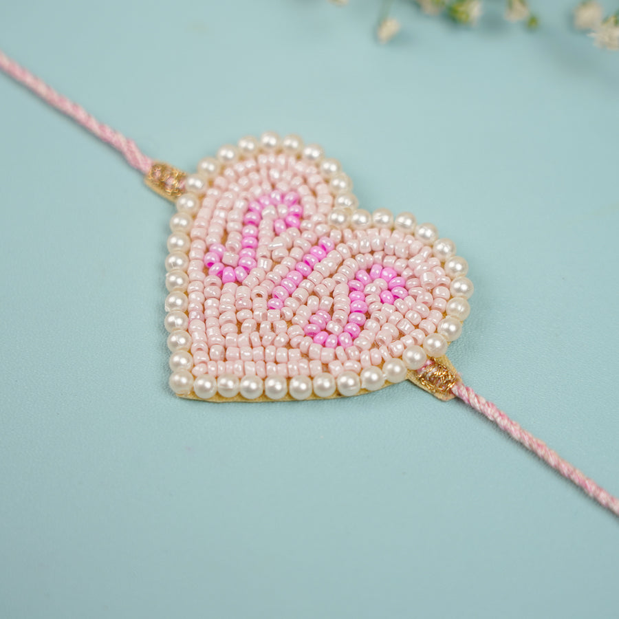 Handmade Beaded Sis Heart Theme Rakhi With Roli Chawal For Sisters - Close-up of Heart Rakhi