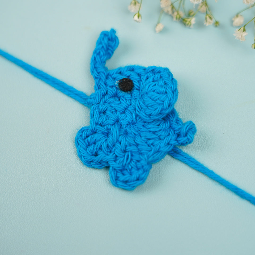 Customized Handmade Crochet Elephant Theme Rakhi With Roli Chawal - Blue Rakhi Close-up Front View