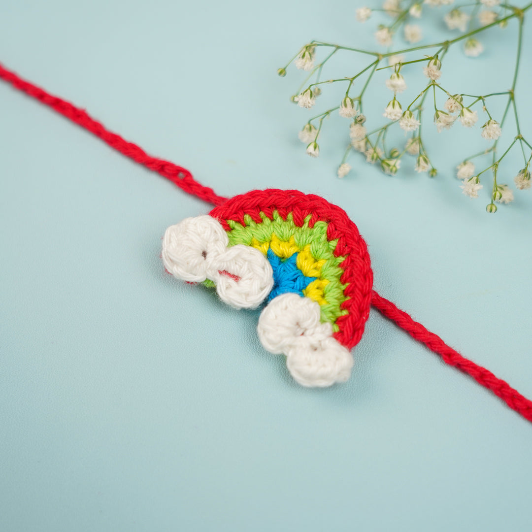Handmade Crochet Rainbow Rakhi With Roli Chawal - Close-up of Rakhi with Flowers