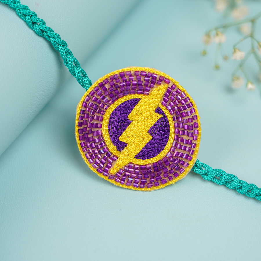 Handmade Beaded Flash Theme Rakhi With Roli Chawal For Brother - Close-up of Rakhi Thread Center