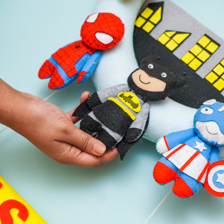 Handmade Personalized Superhero Themed Felt Kids Name Hanging - Hand Holding Product with Multiple Toys