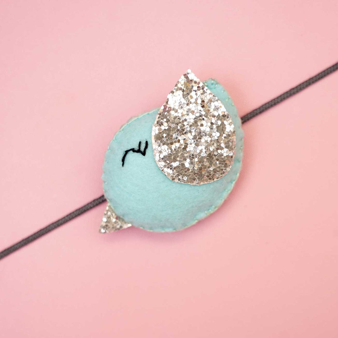 Handmade Bird Felt Rakhi With Roli Chawal - Close-up of Blue Bird Design