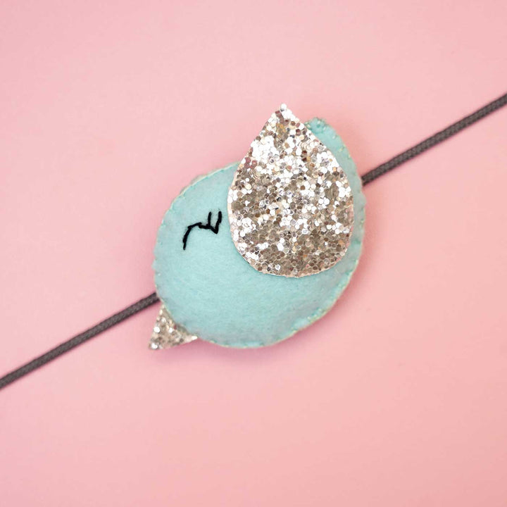 Handmade Bird Felt Rakhi With Roli Chawal - Close-up of Blue Bird Design