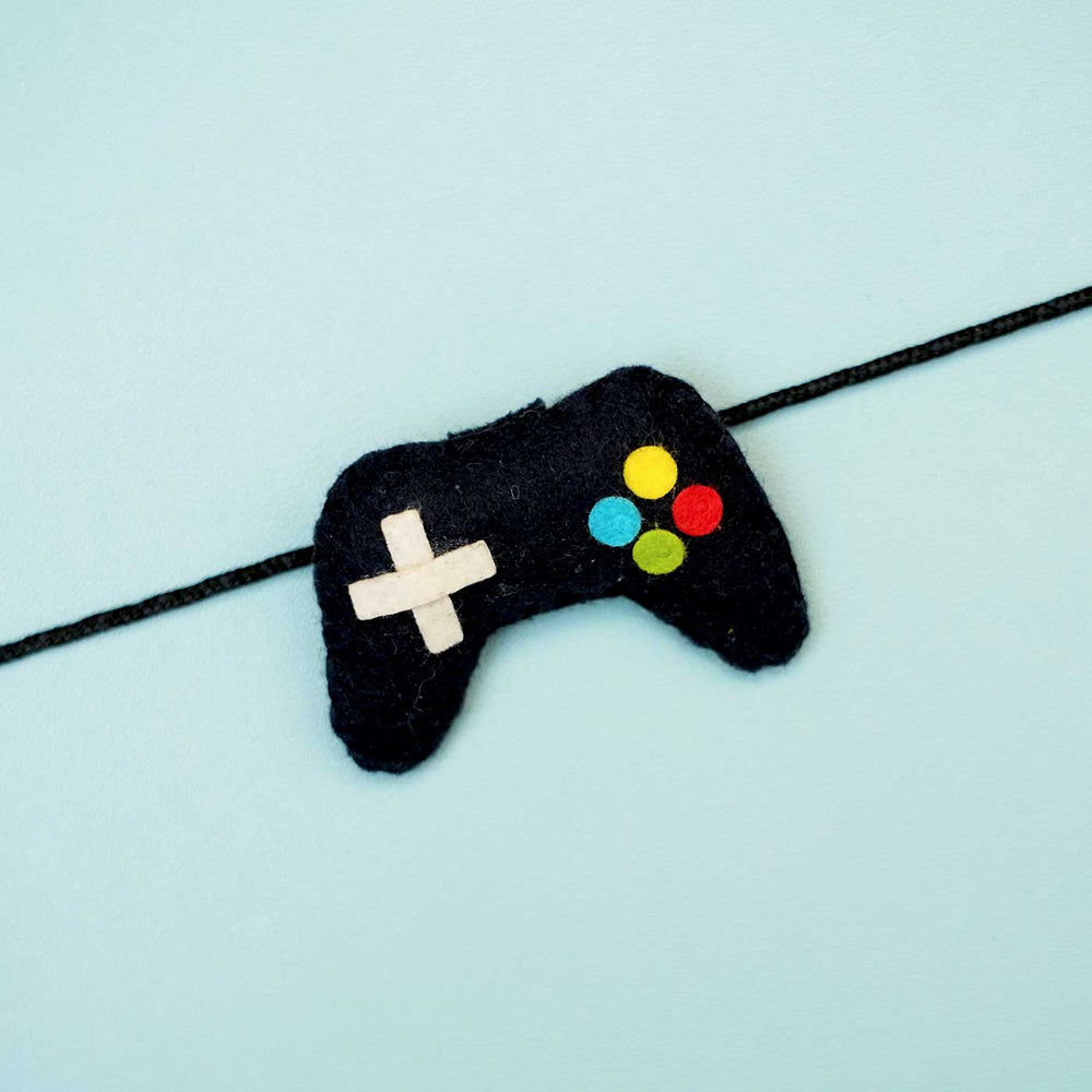 Handmade Controller Felt Rakhi With Roli Chawal - Close-up of Game Controller Bracelet