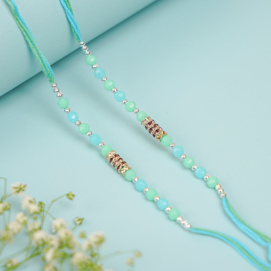 Handmade Beaded Sea Green Rakhi With Roli Chawal Set Of 2 - Close-up of two bracelets