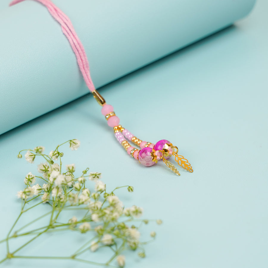 Handmade Pink Beads And Leaf Lumba Rakhi For Bhabhi With Roli Chawal - Close-up of Necklace Pendant