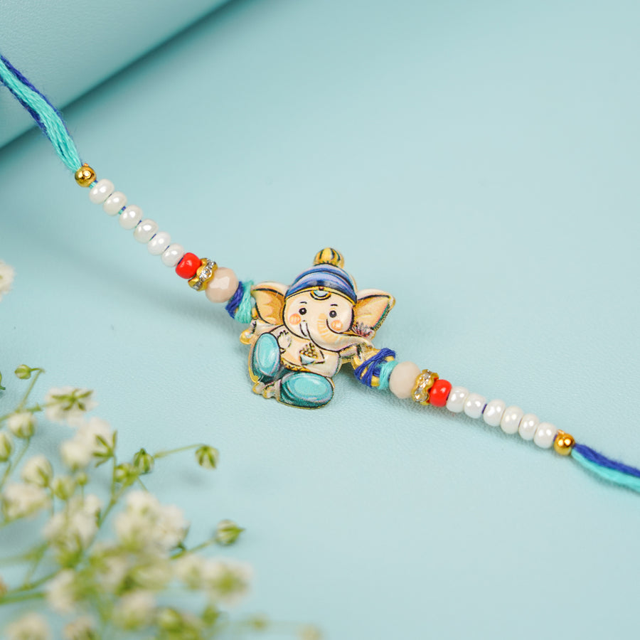 Handmade Baal Ganesha Rakhi With Roli Chawal - Close-up of Rakhi Centerpiece