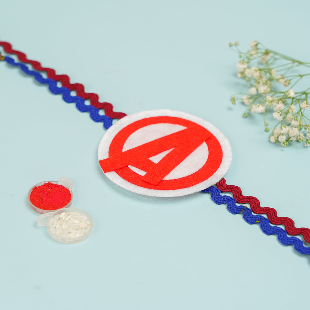 Handmade Avengers Theme Felt Kids Rakhi With Roli Chawal - Front View with Pooja Items Nearby