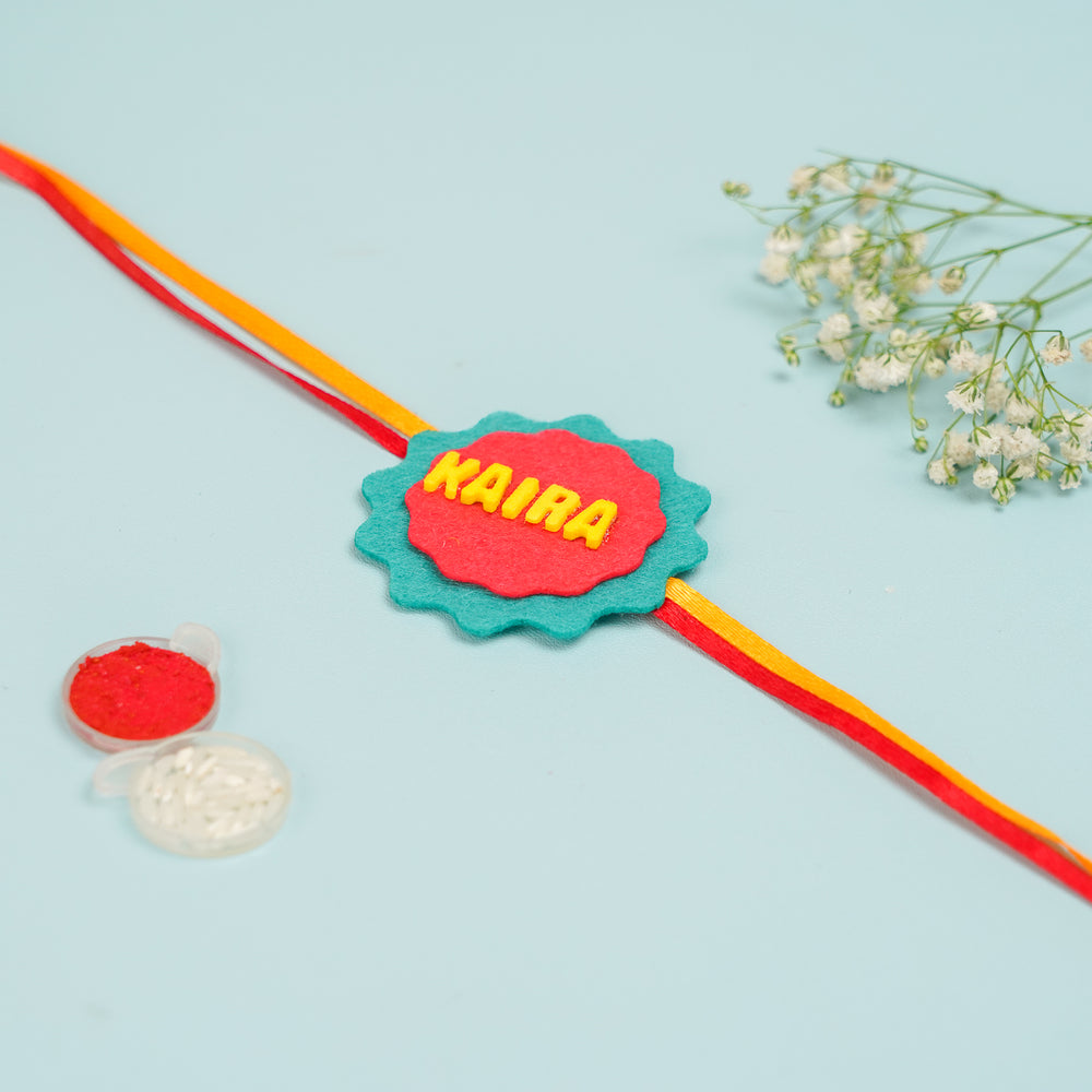 Personalized Handmade Red And Green Felt Kids Rakhi With Roli Chawal - Full View with Decorative Elements