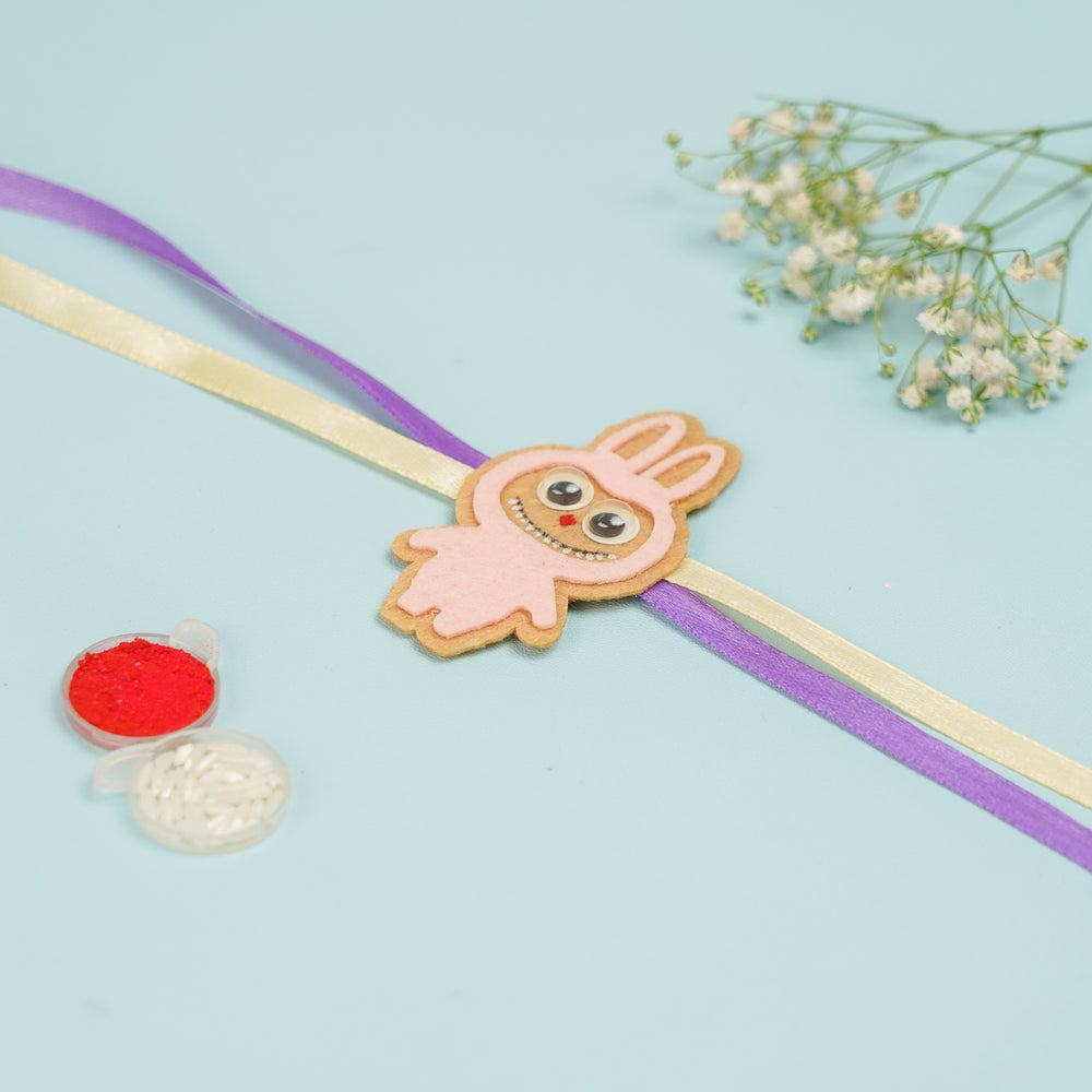 Handmade Labubu Doll Felt Kids Rakhi With Roli Chawal - Front View with Color Powder