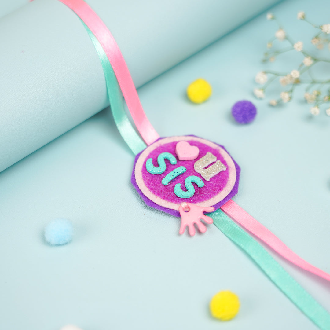 Handmade Sister Felt Rakhi Hamper With Roli Chawal Includes 1 Decorative Plaque 1 Rakhi - Wristband Draped Over Blue Surface