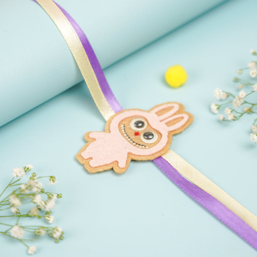 Handmade Labubu Doll Felt Kids Rakhi With Roli Chawal - Front View with Decorative Props