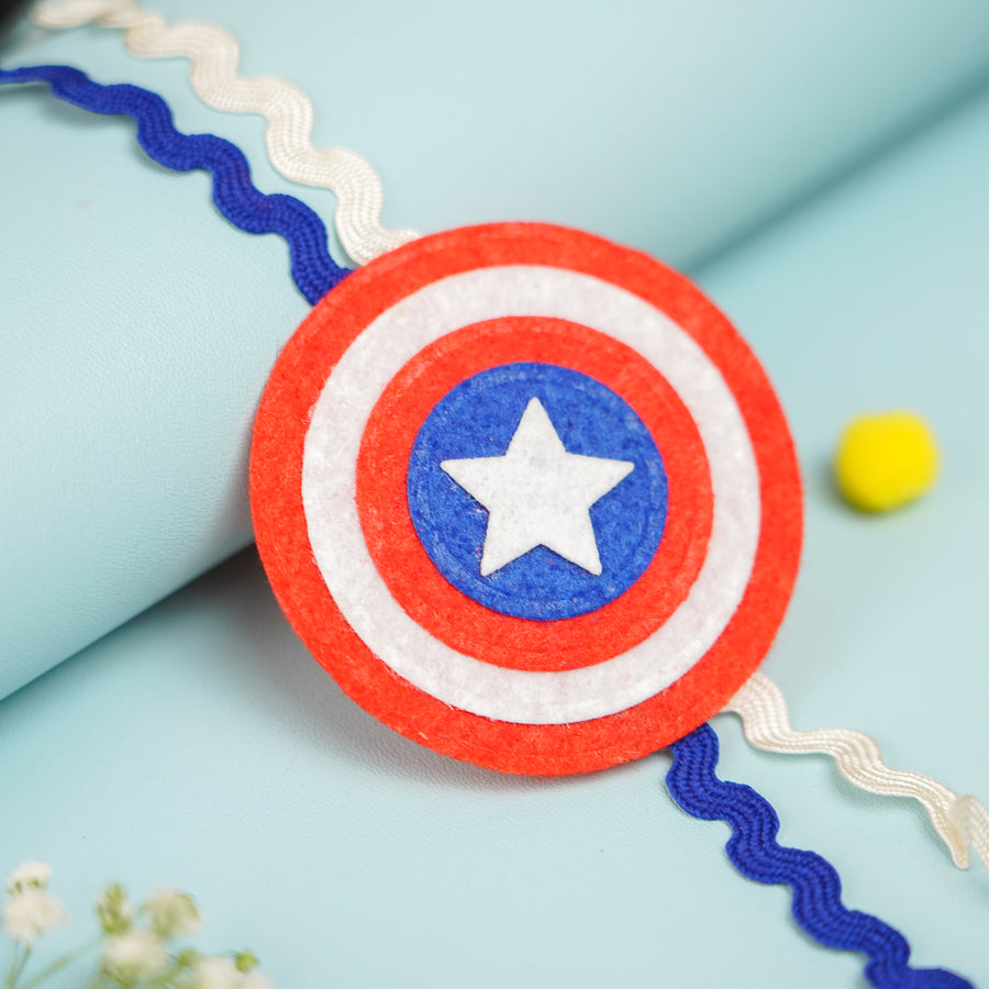 Handmade Captain America Theme Felt Kids Rakhi With Roli Chawal 2 - Close-up of Shield Patch