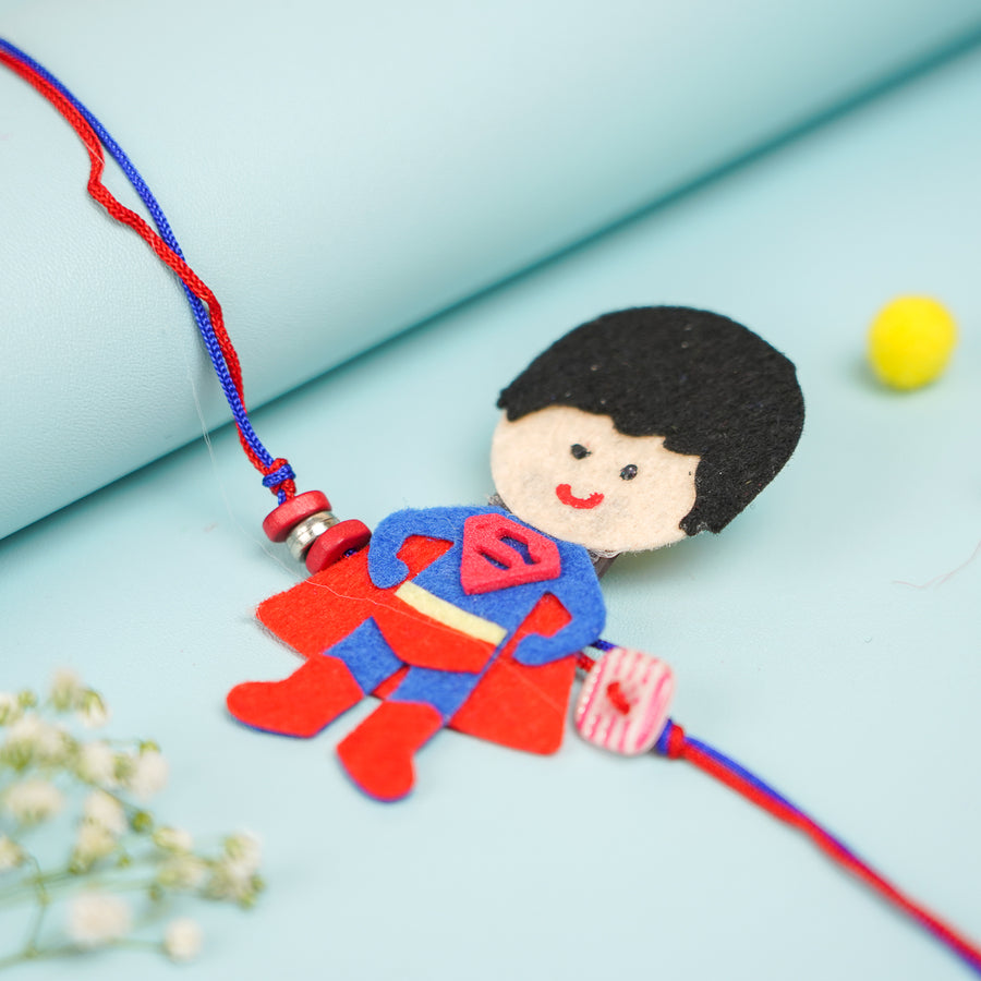 Handmade Superman Theme Felt Kids Rakhi With Roli Chawal - Close-up View