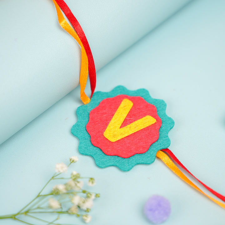 Personalized Handmade Name Initial Felt Kids Rakhi With Roli Chawal - Close-up of central design