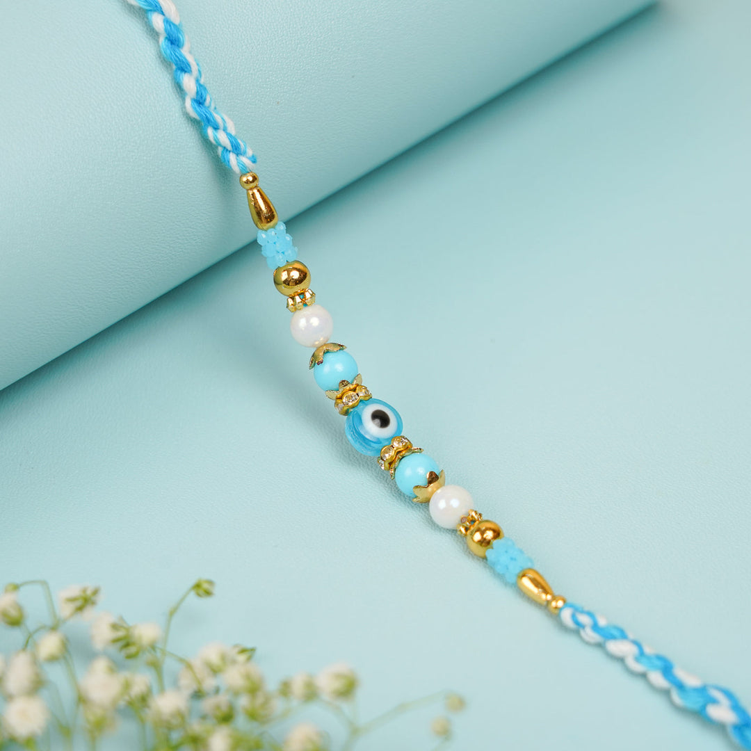 Handmade Beaded Blue Evil Eye Bhaiya Bhabhi Rakhi With Roli Chawal Set Of 2 - Single Bracelet Close-up