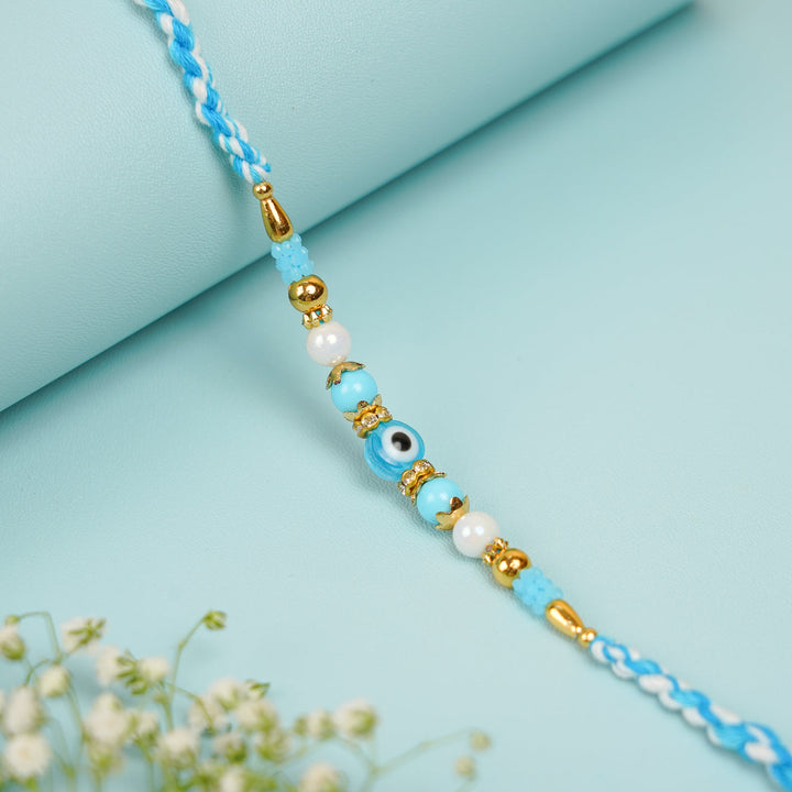 Handmade Beaded Blue Evil Eye Bhaiya Bhabhi Rakhi With Roli Chawal Set Of 2 - Single Bracelet Close-up