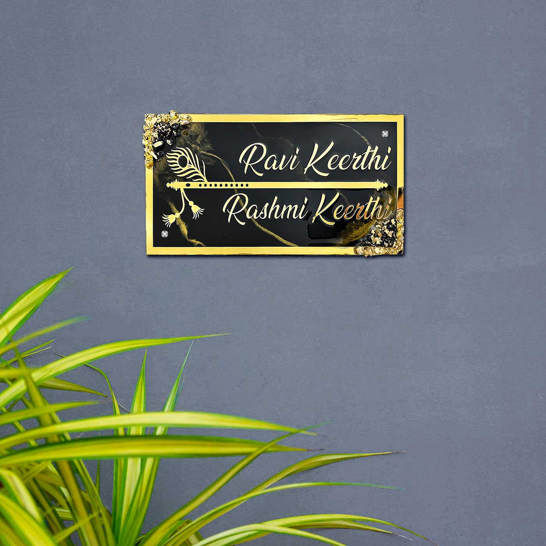Personalized Resin Chocolate Brown And Gold Name Plate - Mounted on Wall with Plants Nearby