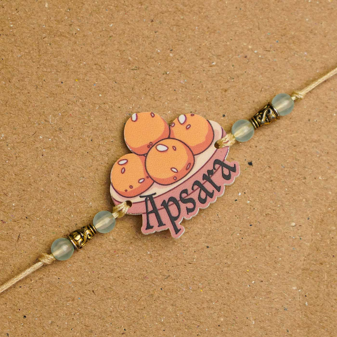 Personalized Handmade Laddu Acrylic Kids Rakhi With Roli Chawal - Close-up of Rakhi with name