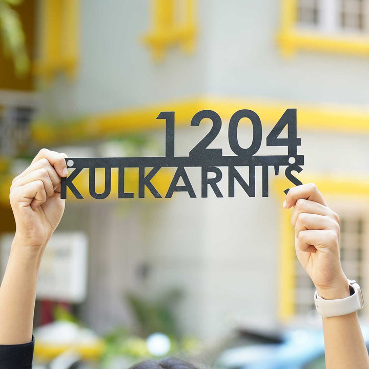 Personalized Modern Weatherproof Name Plate With House Number - Held in Hands Against Background