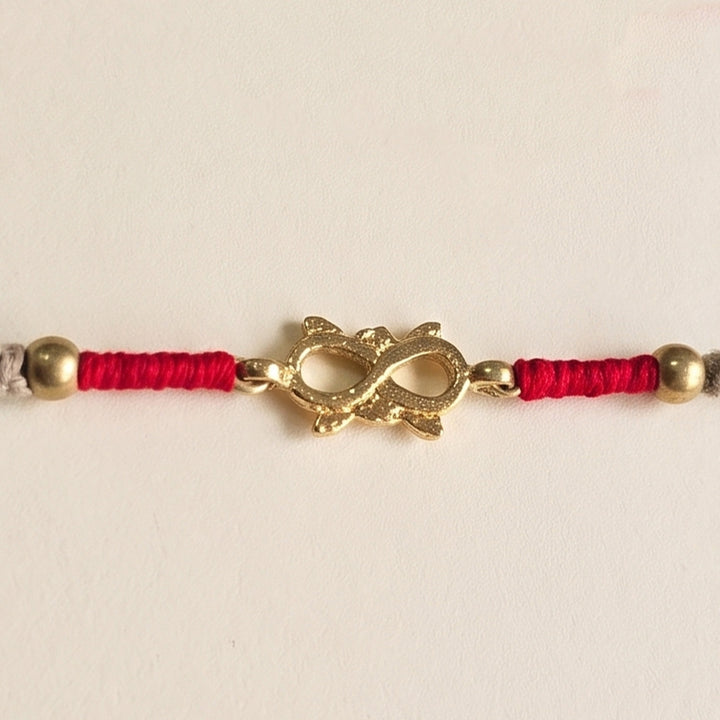 Handcrafted Infinity Brass Motif Rakhi With Roli Chawal For Brother