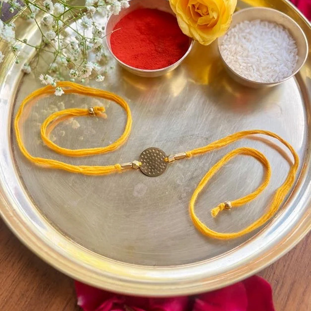 Handcrafted Circular Hammered Brass Charm Rakhi With Roli Chawal For Brother