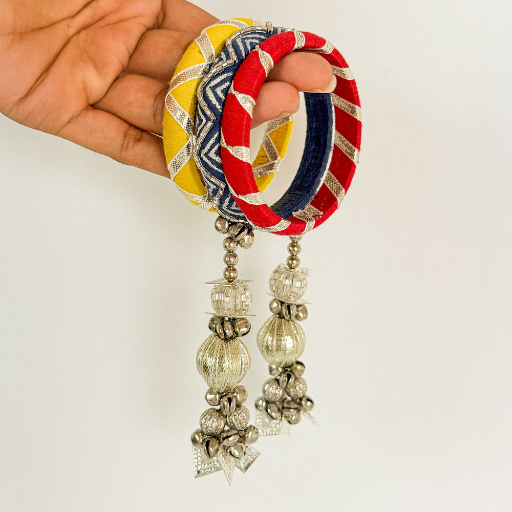 Handmade Beaded Traditional Ghungroo And Zari Cotton Bangle Lumba With Roli Chawal For Bhabhi - Hand Holding Bangles Close-up