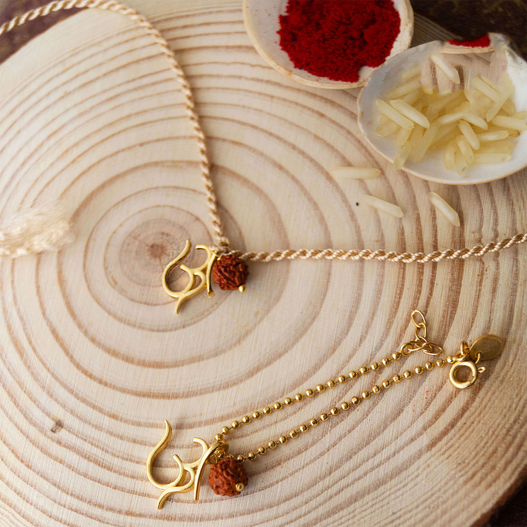 Sacred Om With Rudraksh Gold Plated Sterling Silver Rakhi & Lumba Set With Roli Chawal For Bhaiya Bhabhi | Set of 2