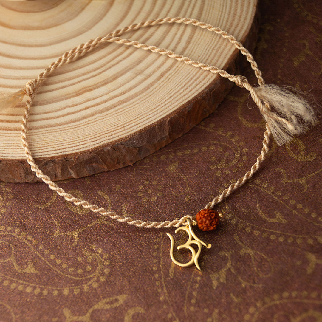 Sacred Om With Rudraksh Gold Plated Sterling Silver Rakhi & Lumba Set With Roli Chawal For Bhaiya Bhabhi | Set of 2