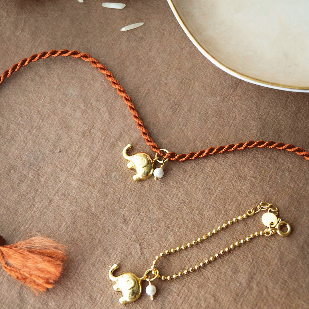 Cute Elephant With Pearl Gold Plated Sterling Silver Rakhi & Lumba Set With Roli Chawal For Bhaiya Bhabhi | Set of 2