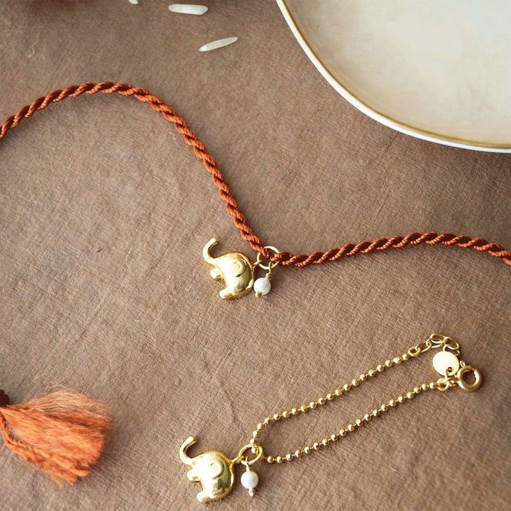 Cute Elephant With Pearl Gold Plated Sterling Silver Rakhi & Lumba Set With Roli Chawal For Bhaiya Bhabhi | Set of 2