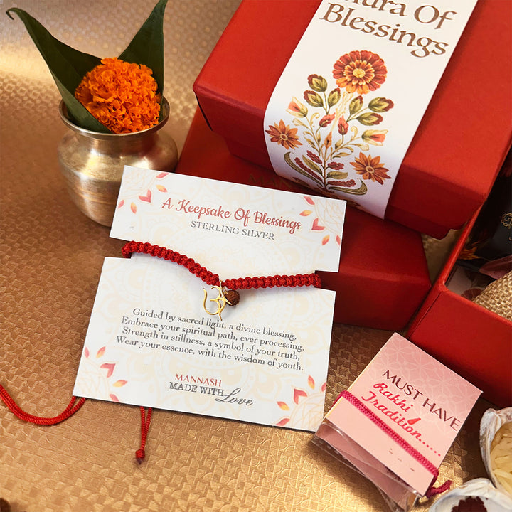 Aura Of Blessings Om With Rudraksh Gold Plated Sterling Silver Charm Rakhi Hamper With Chocolates, Nuts & Roli Chawal For Brother