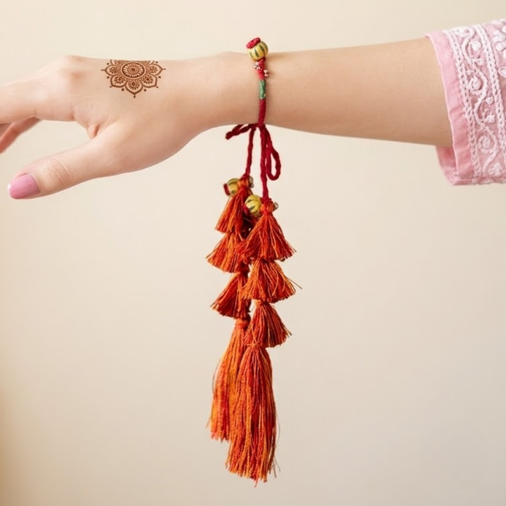 Handmade Reusable Red Potli Ghungroo & Jhumki Lumba Rakhi For Bhabhi