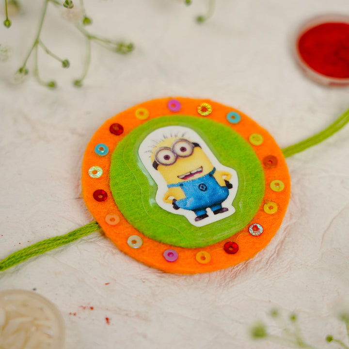 Handmade Minion Kids Rakhi With Roli Chawal - Close-up of Central Ornament