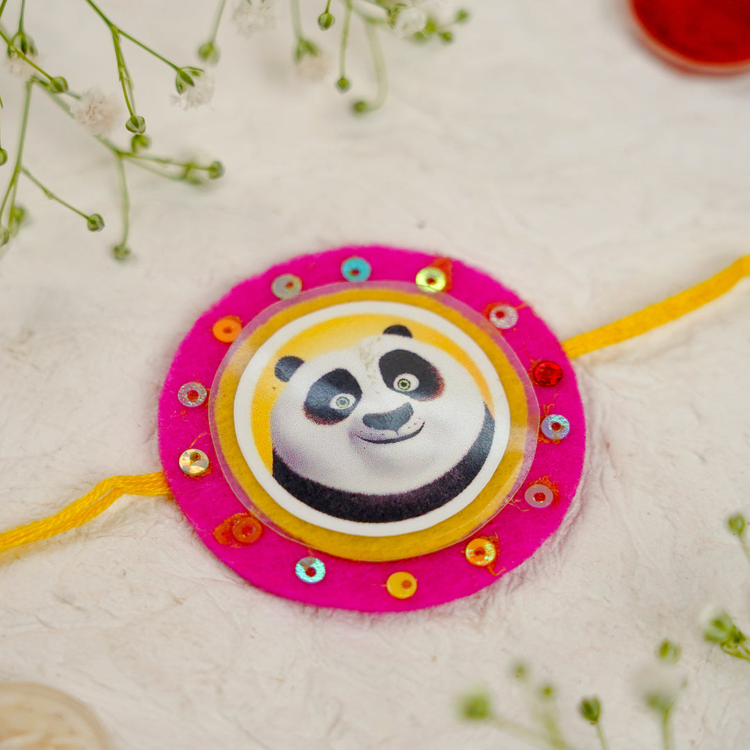 Handmade Kung Fu Panda Kids Rakhi With Roli Chawal - Close-up on Flat Surface