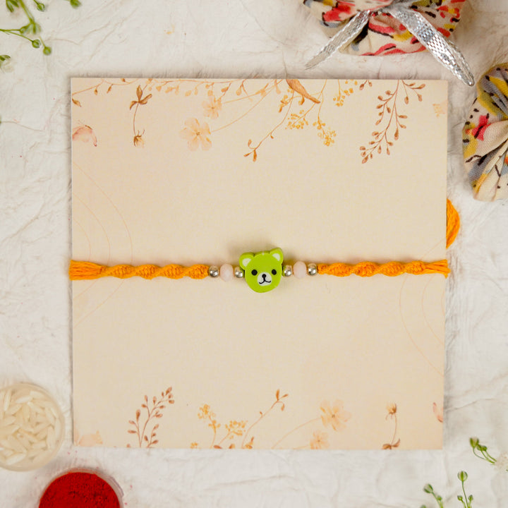 Handmade Green Bear Kids Rakhi With Roli Chawal - Front View on Decorative Card