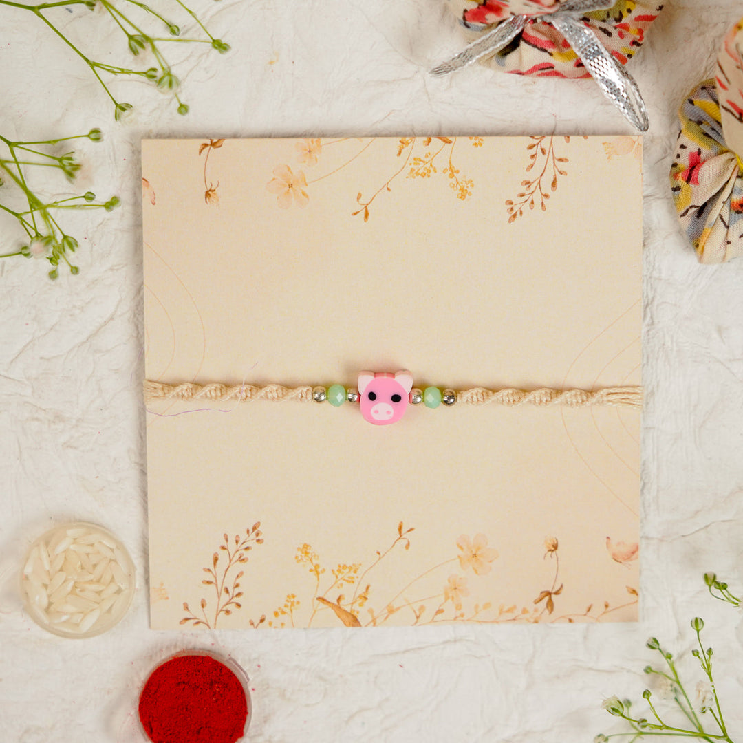 Handmade Pig Kids Rakhi With Roli Chawal - Displayed on decorative card