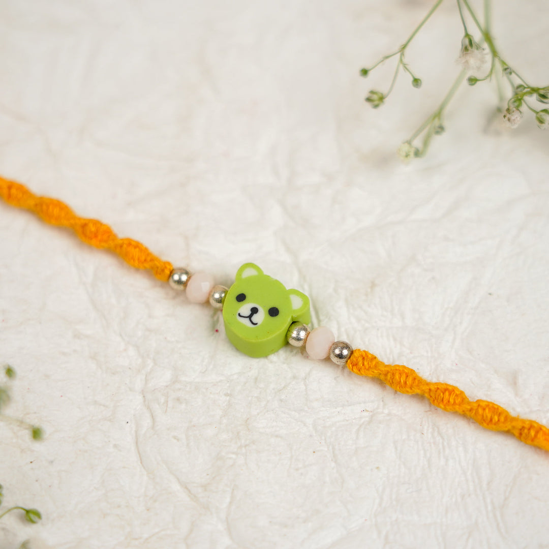 Handmade Green Bear Kids Rakhi With Roli Chawal - Close-up of centerpiece detail