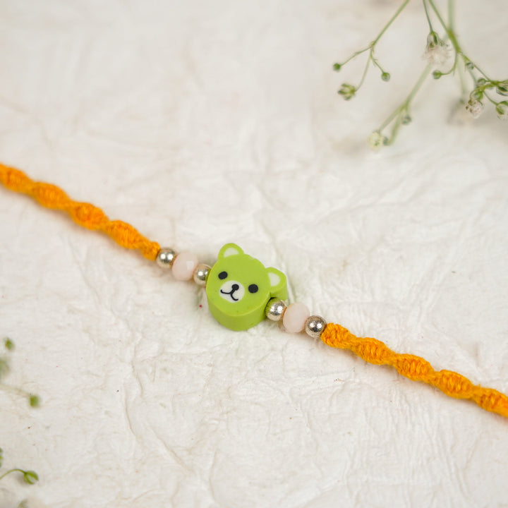 Handmade Green Bear Kids Rakhi With Roli Chawal - Close-up of centerpiece detail
