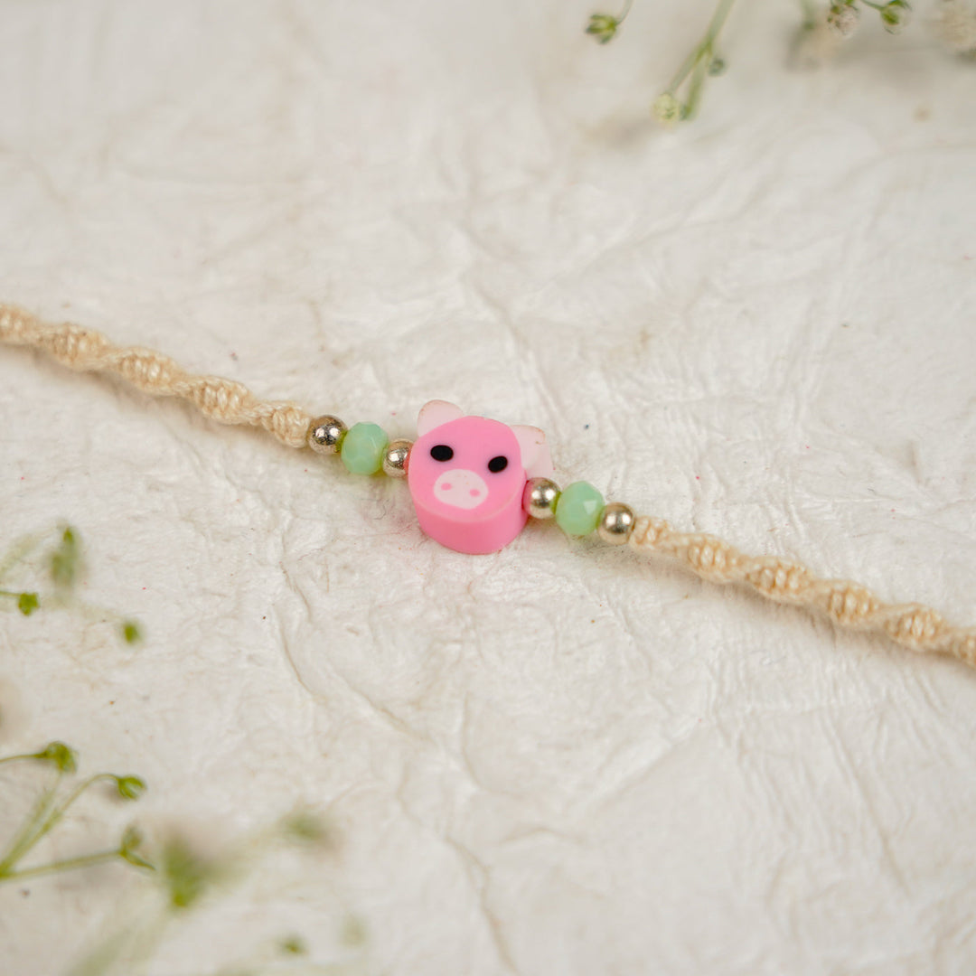 Handmade Pig Kids Rakhi With Roli Chawal - Close-up of charm detail