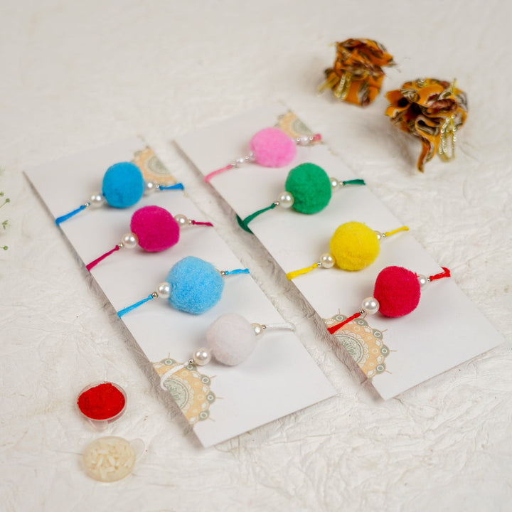 Handmade Large Pompom Rakhi With Roli Chawal Set Of 12 - Close-up of Bracelets on Cards