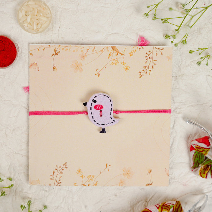 Handmade Bird Kids Rakhi With Roli Chawal - Top view of charm on string