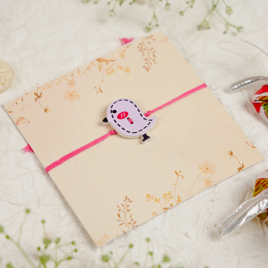 Handmade Bird Kids Rakhi With Roli Chawal - Close-up of bird charm bracelet