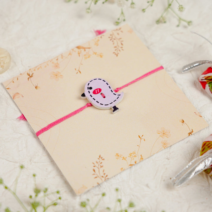 Handmade Bird Kids Rakhi With Roli Chawal - Close-up of bird charm bracelet